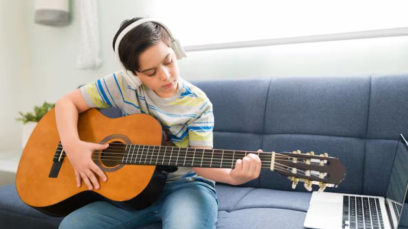 Cách Cảm Âm Guitar: Lộ Trình Bài Bản Để Đệm Mọi Bài Hát 5 Người chơi nghe nhạc và tái tạo lại giai điệu trên đàn guitar bằng cảm âm