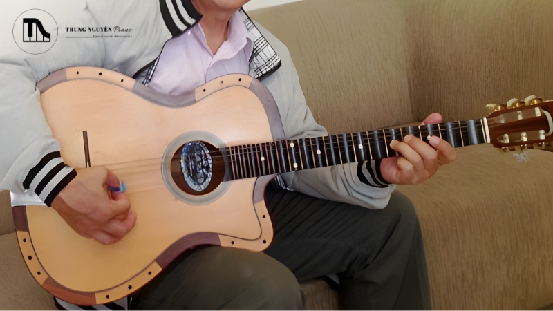 Cận cảnh bàn tay phải đang cầm phím gảy đúng kỹ thuật